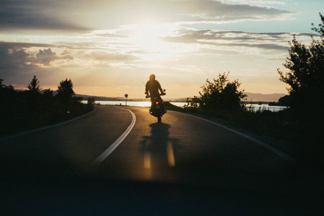 person riding a motorcycle during golden hour